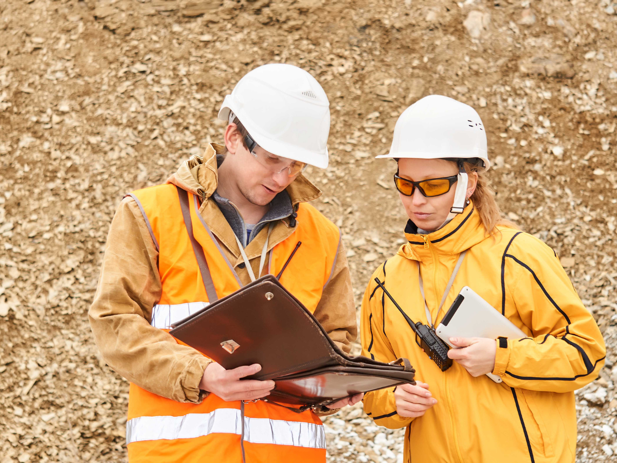Man and woman on mine site in hi-vis and hard hats